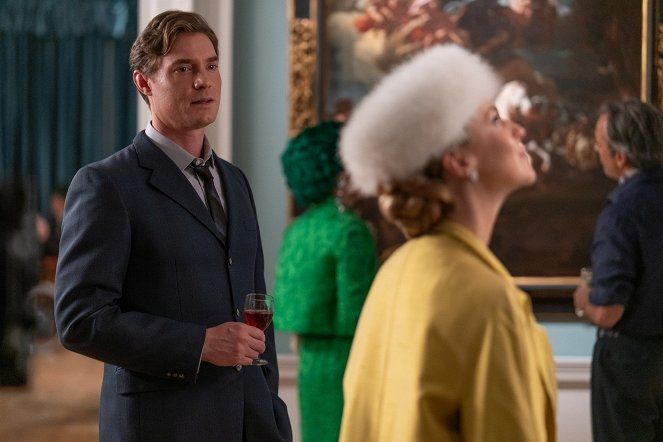 Screenshot from Sister Boniface Mysteries, in which a handsome man stares longingly at a beautiful woman in a 1950's art gallery.