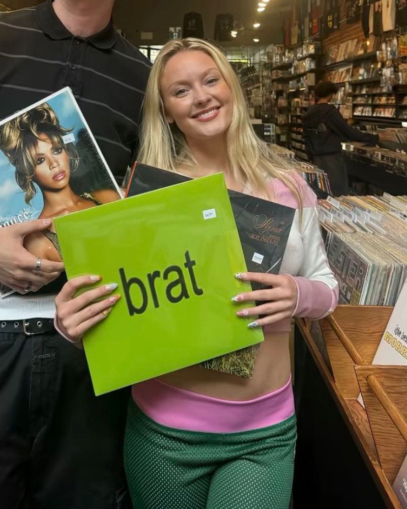 zara larsson holding brat, sos deluxe & someone off to the side holding b’day by beyonce 
