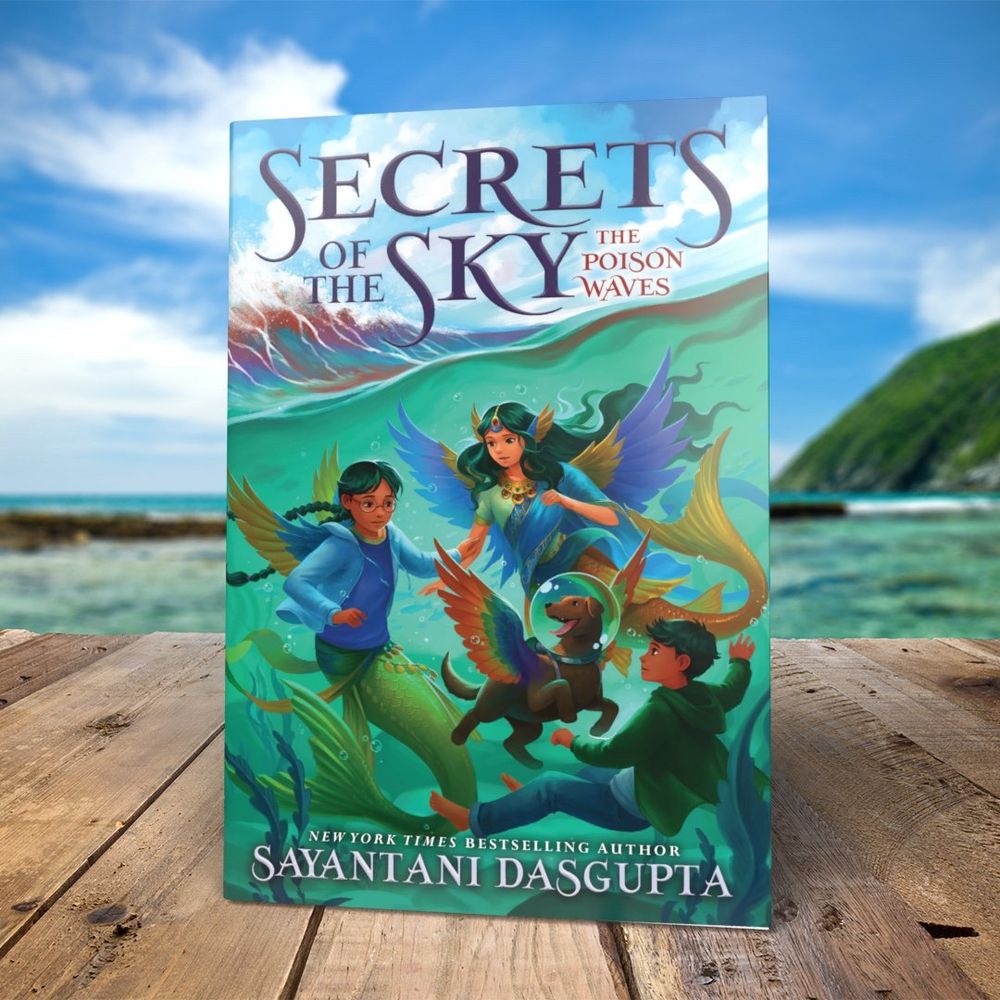 2 winged mermaids a boy and a smiling winged and helmet wearing dog under the waves