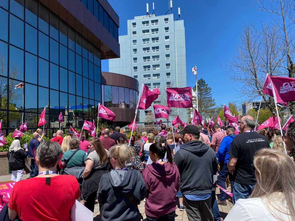 CUPE delegates at a rally with CUPE NS flags