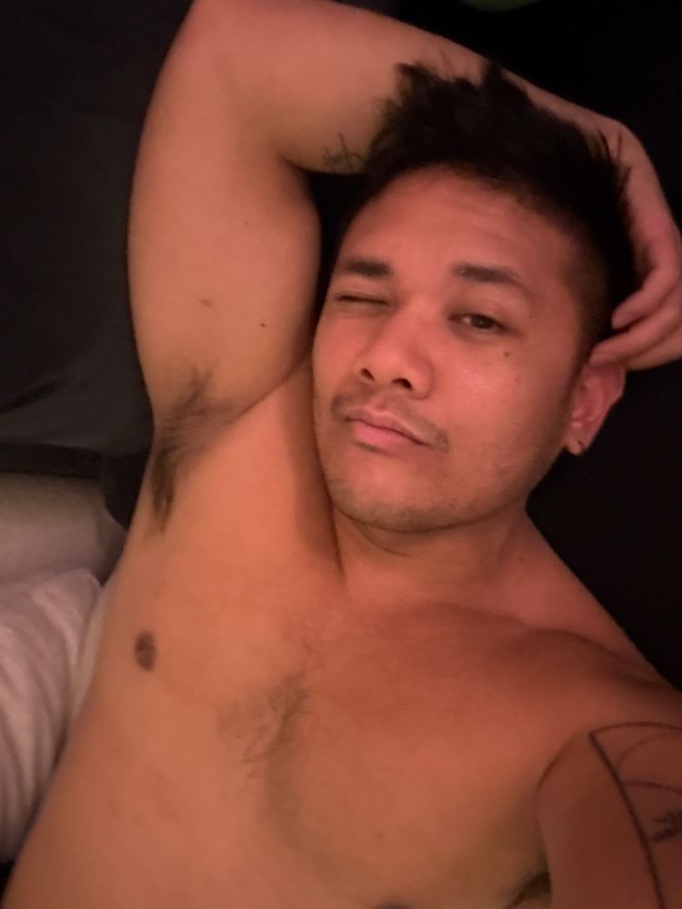 sick shirtless man laying down on couch