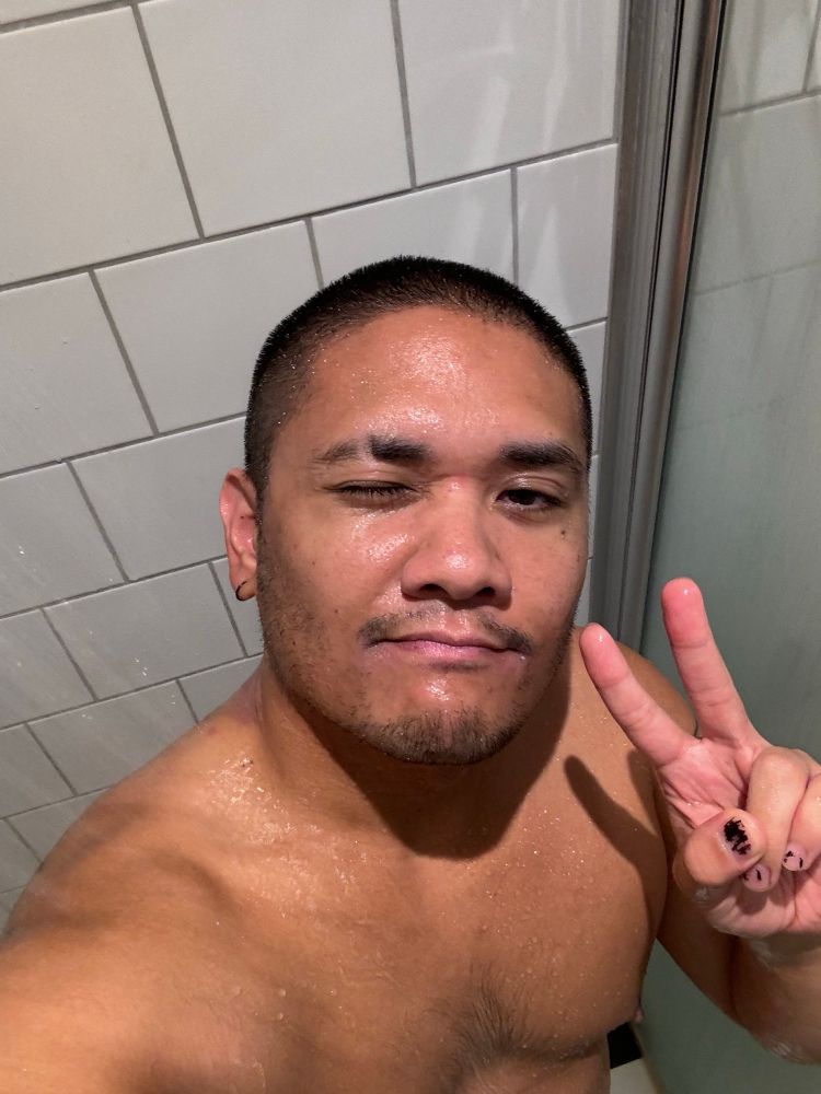 man with a buzz cut in the shower