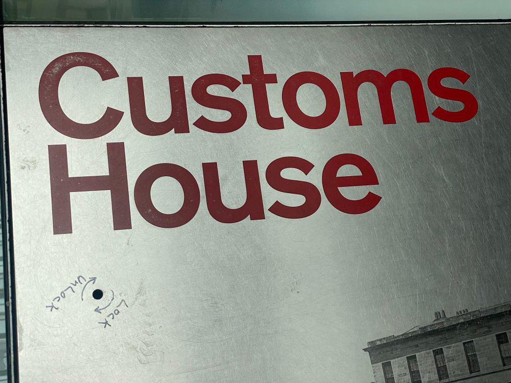 A close up of the access panel, with “Lock/Unlock” and arrows in felt tip around a keyhole