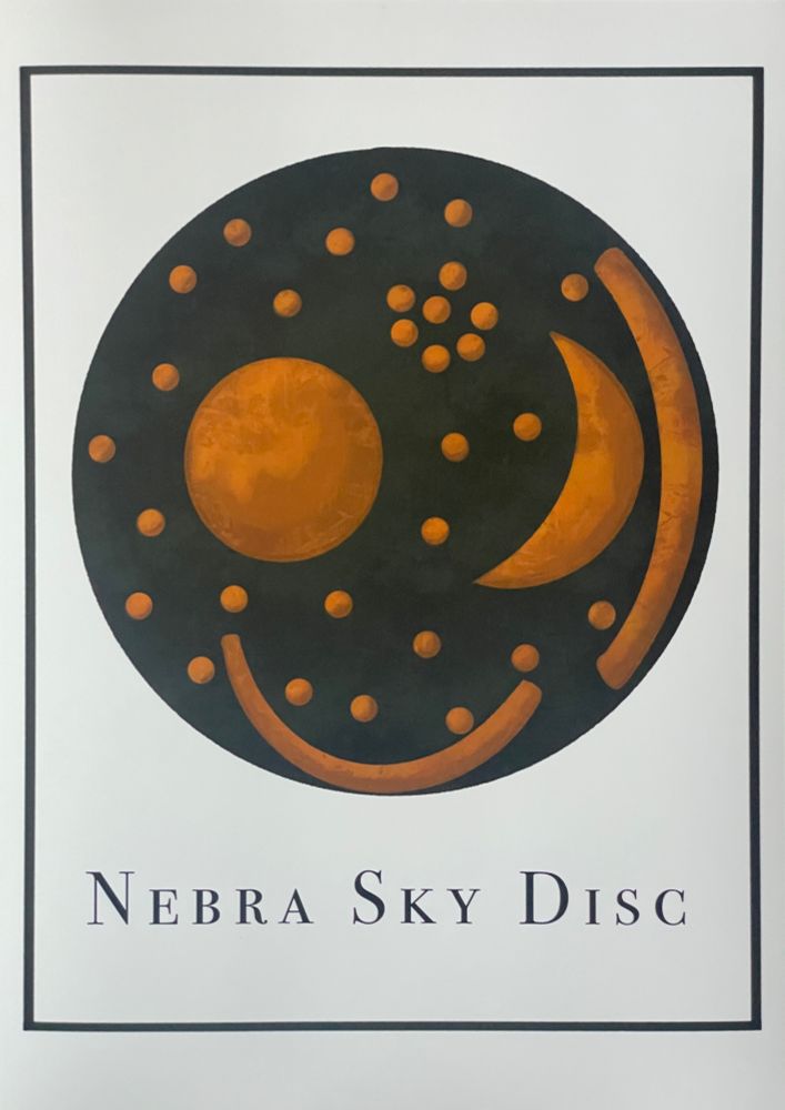Circle shape with dark green colour and gold tone moon and circle shapes scattered; below is black text “nebra sky disc” and black border. All on white surface