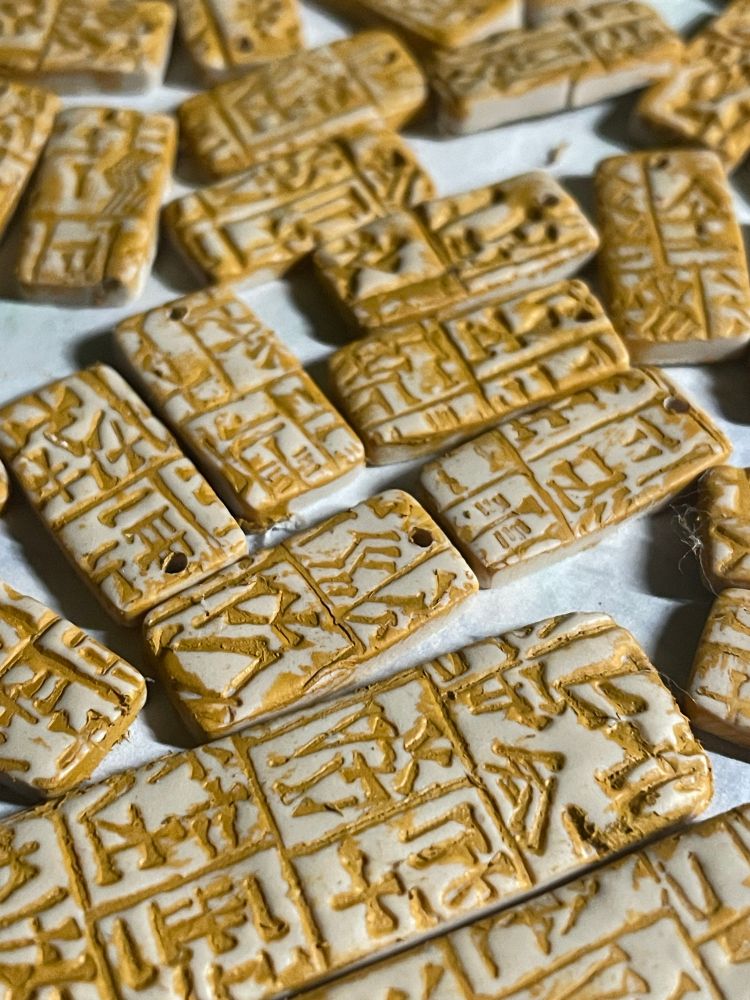 Close up of tan painted rectangles with impressed cuneiform