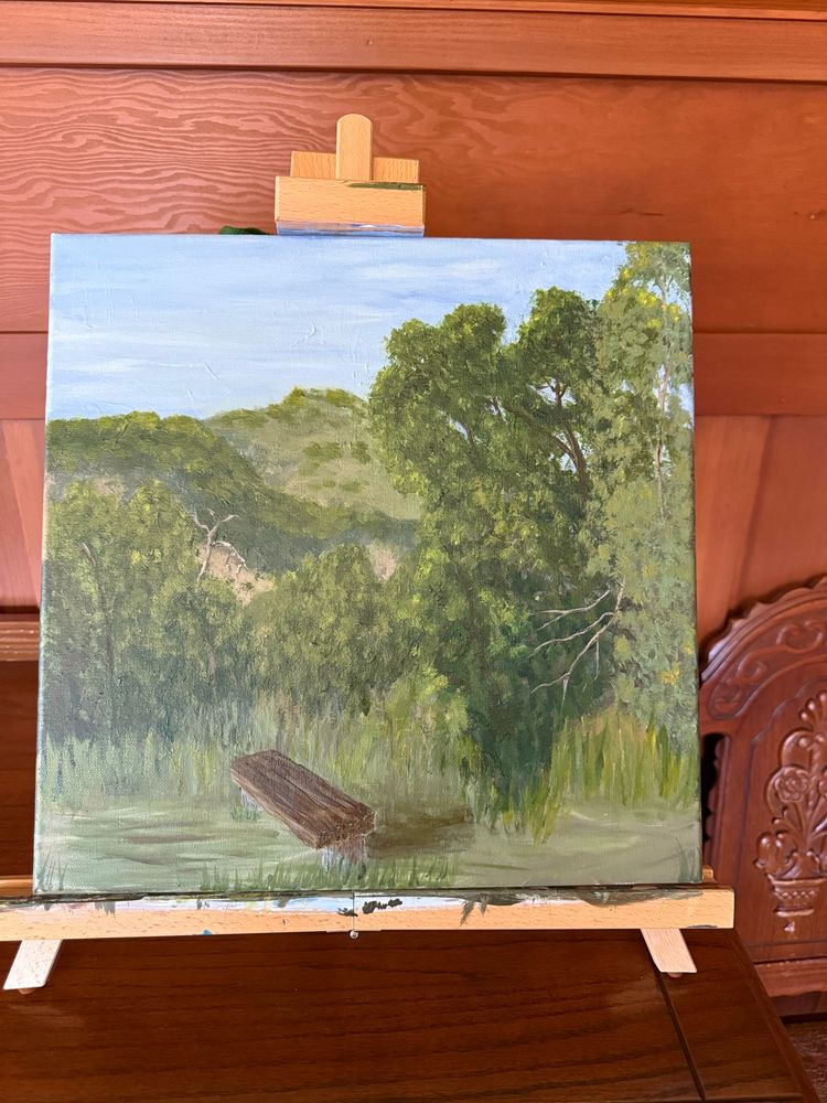 A bench with hills and trees