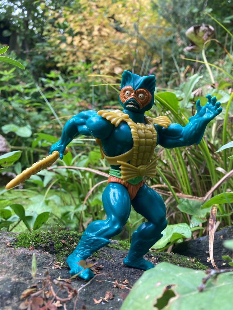 Masters of the Universe Mer-Man - a turquoise mer-creature in yellow fish scale armour hoofing a yellow sawshark rostrum  sword in a dynamic pose 