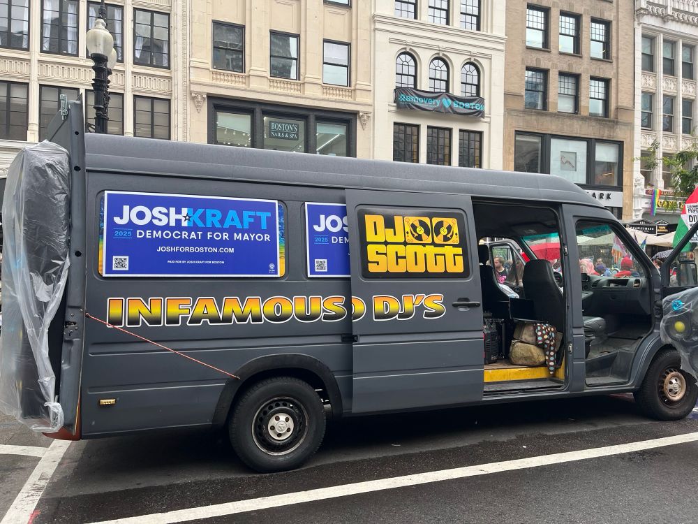 commercial dj van with a couple Josh Kraft signs stuck on it