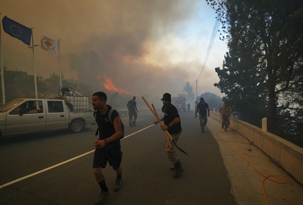 Residents try to extinguish the blazes in Omodos village, Cyprus, during a massive wildfire on the southern side of the east Mediterranean island nation’s Troodos mountain range, Thursday, July 24, 2025. (AP Photo/Petros Karadjias)