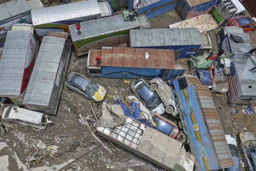 Damaged vehicles are seen after severe monsoon rains flooded the Bhotekoshi River and swept away a key bridge connecting the country with China at Rasuwagadi,120 kilometers (75 miles) north of the capital, Kathmandu, Nepal, Wednesday, July, 9, 2025. (AP Photo/Sujan Gurung)