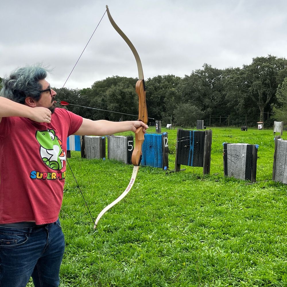 Target practicing with a bow and arrow.