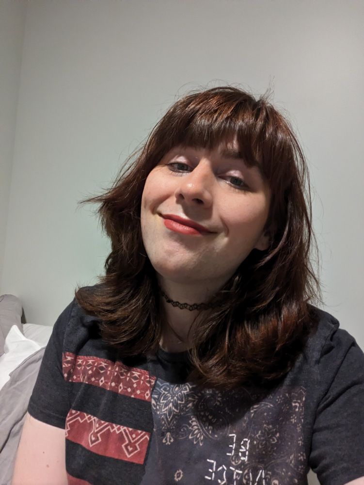 A selfie of Riley with big brown hair