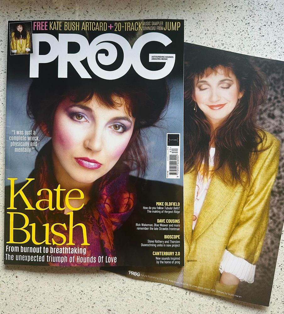 Prog magazine issue 162 with Kate Bush on the cover, in her glam mode with hair up, purples and pinks in her make-up, wearing a black jacket and red-bronze scarf. A free A4 art card has her in in a bright yellow suit jacket with rolled up sleeves, she is smiling and has her eyes closed. All images by Guido Harari from 1985. The feature is about the making of the Hounds Of Love album, which is 40 years old in September. There are other articles on Mike Oldfield, a tribute to Dave Cousins, Bioscope (featuring Steve Rothery), modern Canterbury Scene bands and Michael Giles.