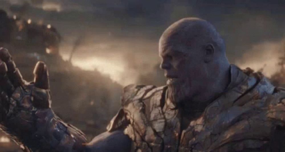 thanos from avengers endgame is saying `` i am inevitable '' with his arm outstretched .