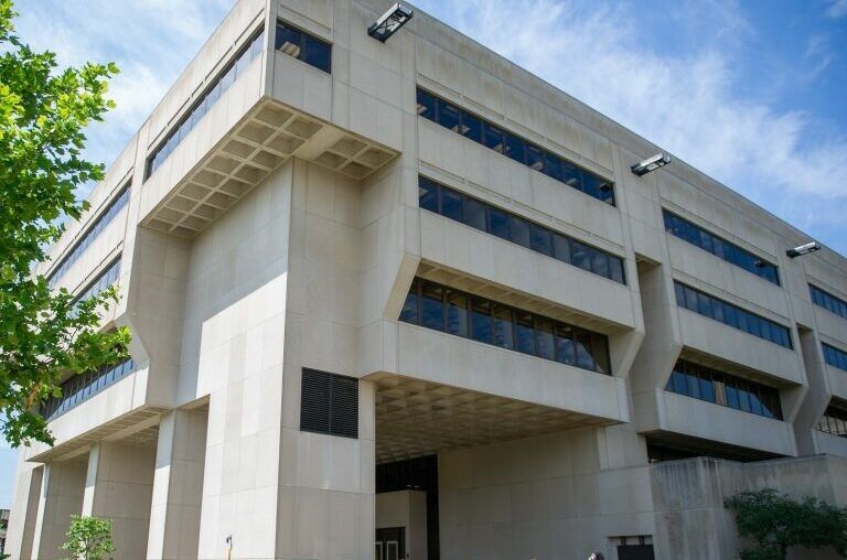 A picture of U Pitt's Posvar Hall facade. Brutalist style with a lighter shade of concrete