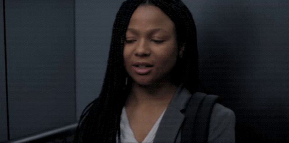 a man and a woman are standing in an elevator and looking at each other