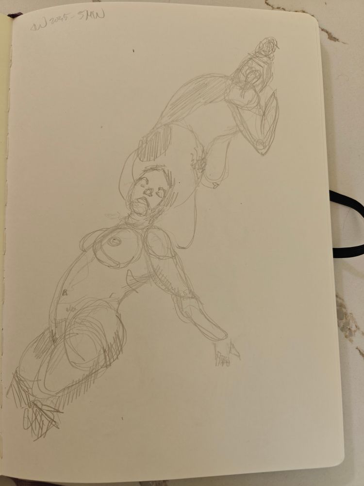 A sketchbook open on a marble table showing loose graphite gestural sketches of a nude woman.