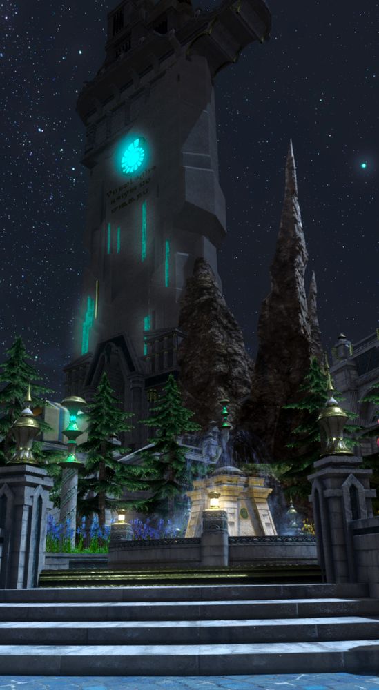 A tall stone edifice, inscribed with Sharlayan sayings and magic, rises against the night sky. Below are tall rocky protrusions and coniferous trees, sitting on the outskirts of a charming fountain surrounded by benches.