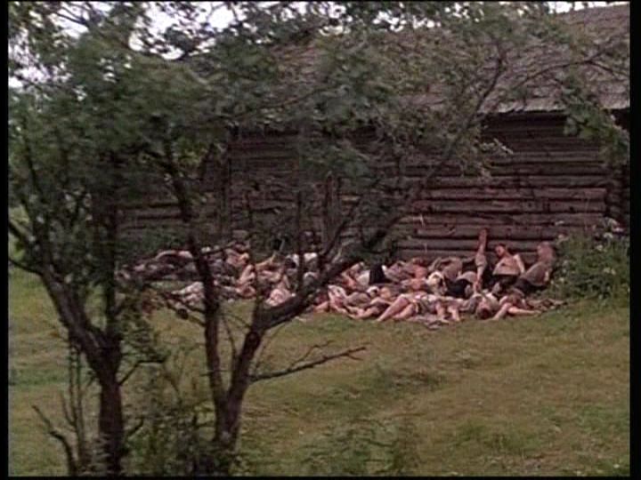 Bodies stacked against the wall of a log cabin from "Come and See."