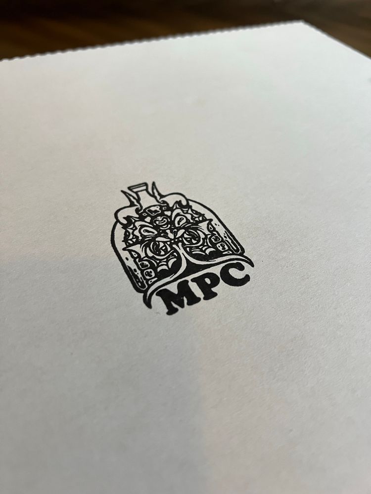 The logo for Midnight Pizza Crü, stamped onto the top of a pizza box
