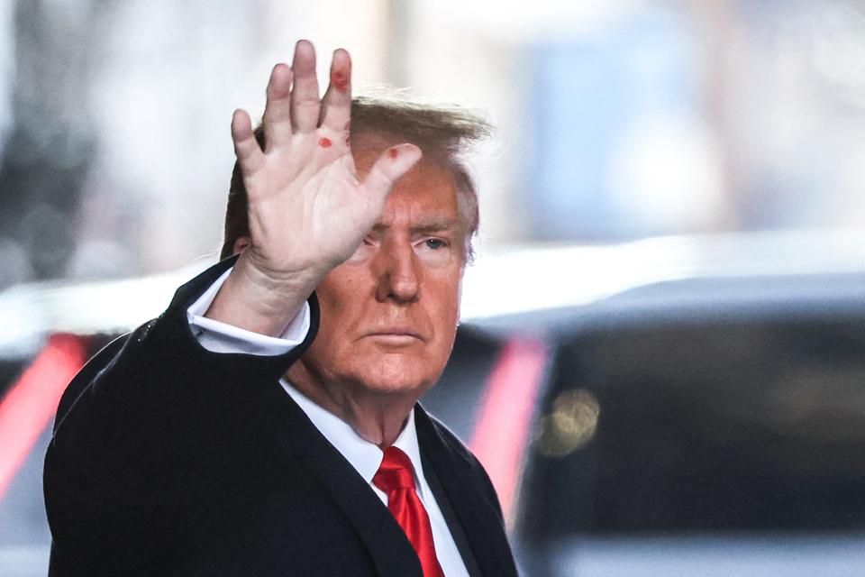 Trump holding up his hand, which now has visible open sores on his fingers. 