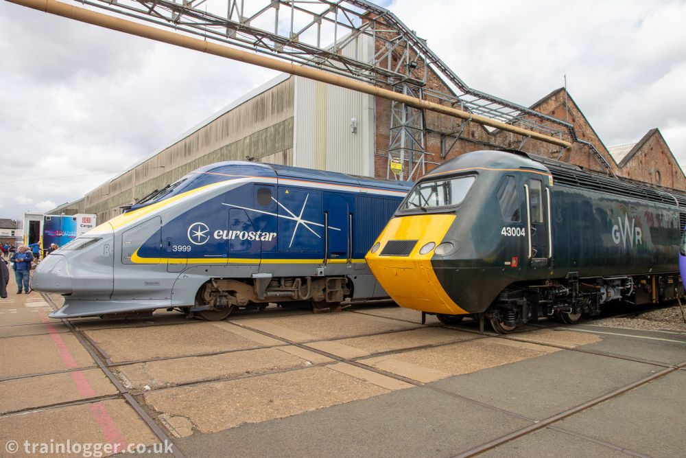 two streamlined locomotives - a green "HST" (high speed train) and a blue Eurostar 
