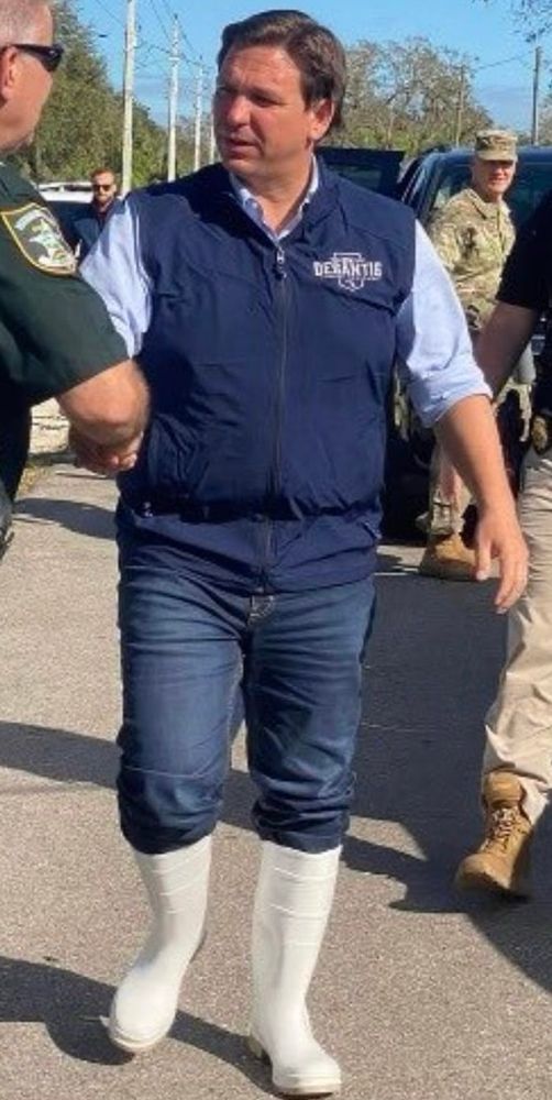 Ron DeSantis wearing white rubber boots. 