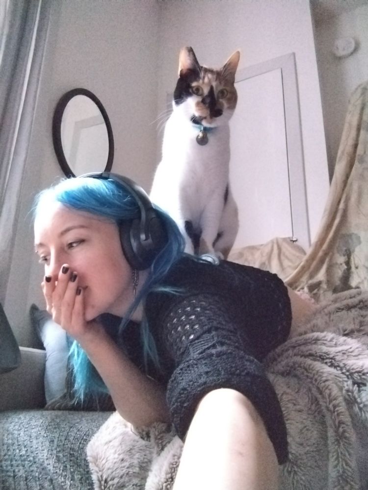 Picture of the artist being stepped on by a Calico cat