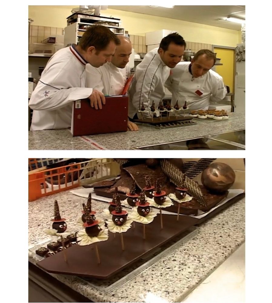 some very serious men peer down at some little chocolate clowns on sticks