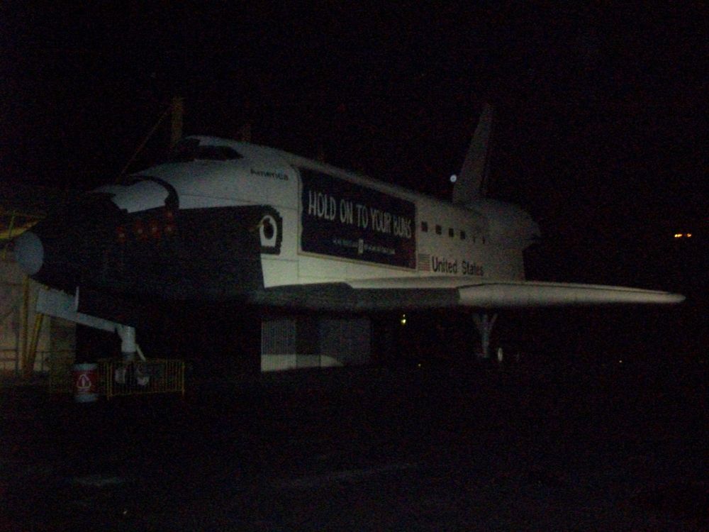 A photo of the Space Shuttle at Six Flags Great America with a "Hold On To Your Buns" banner on it.