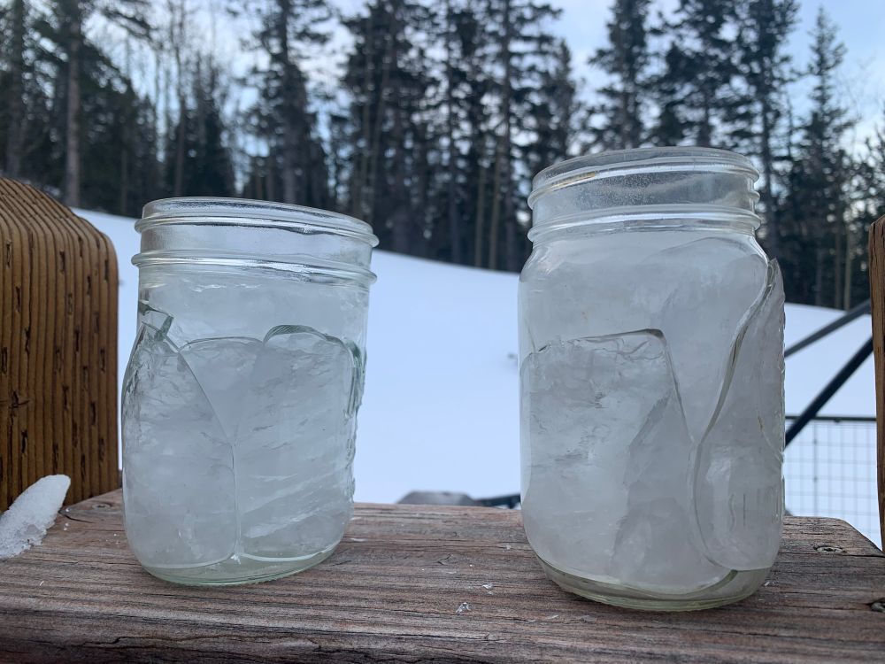 Two broken jars full of frozen water 