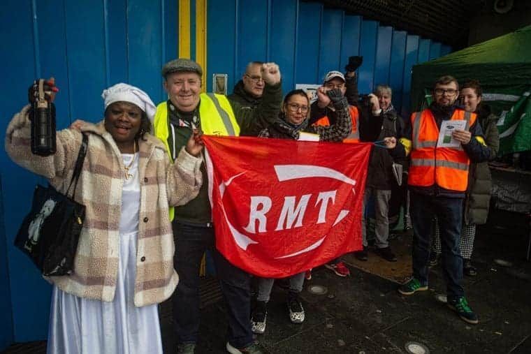 RMT picket line with workers raising a fist in defiant mood (Photo: Guy Smallman)