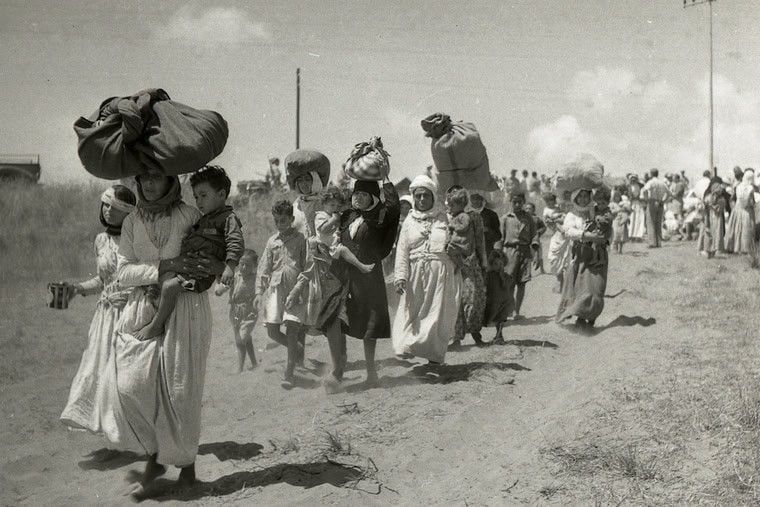 Photo presumably from 1948 of Palestinian refugees – men, women and children – on foot, with whatever possessions they can carry, fleeing the Nakba, the disaster wreaked on them by organised violent Israeli ethnic cleansing.