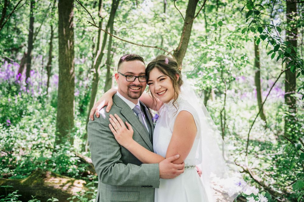 Bride and groom on their wedding day smiling 