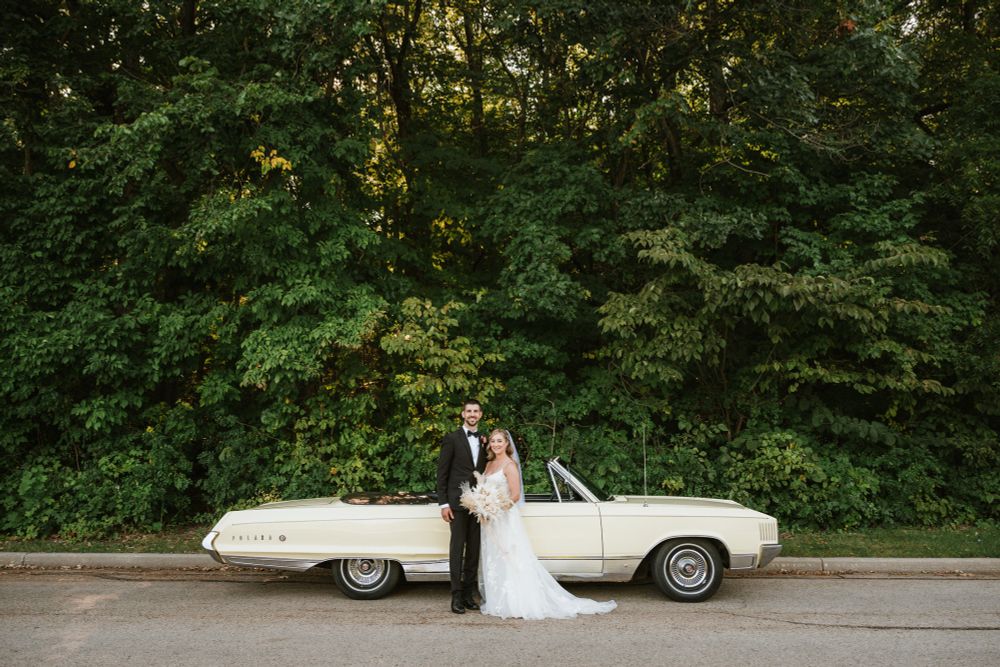 Bride and groom with their Summer Wedding and Classic car