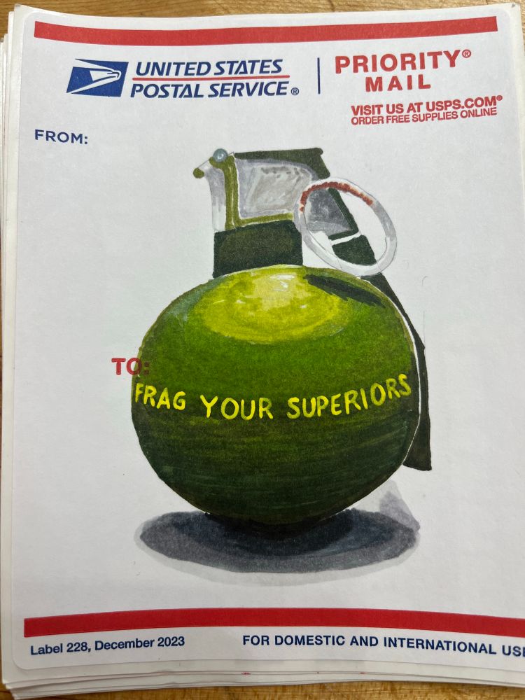 M67 military grenade with “frag your superiors” written in yellow