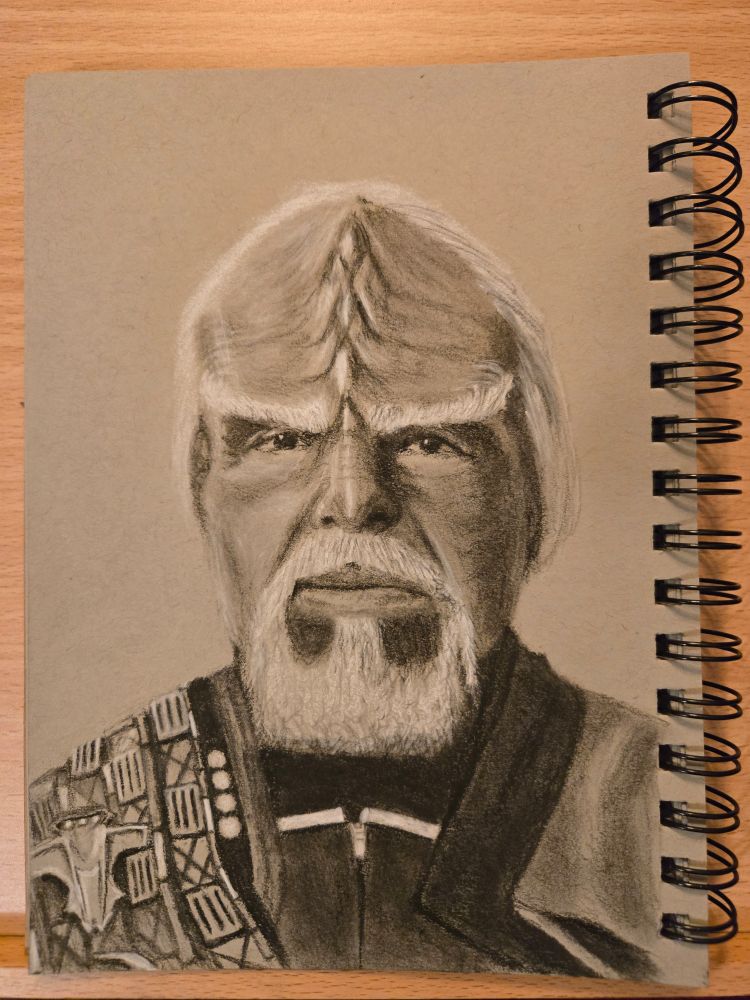 Charcoal and white chalk drawing on grey toned paper of a very distinguished looking old version of the Klingon known as Worf from Star Trek: Picard