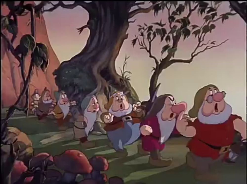 the seven dwarfs from snow white and the seven dwarfs are walking through a forest