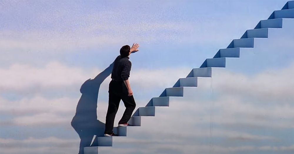 Jim Carrey in “The Truman Show” ascending a cloud-colored staircase. 