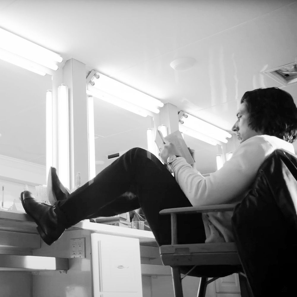 Adam Driver reading behind the scenes of Breitling ad filming
