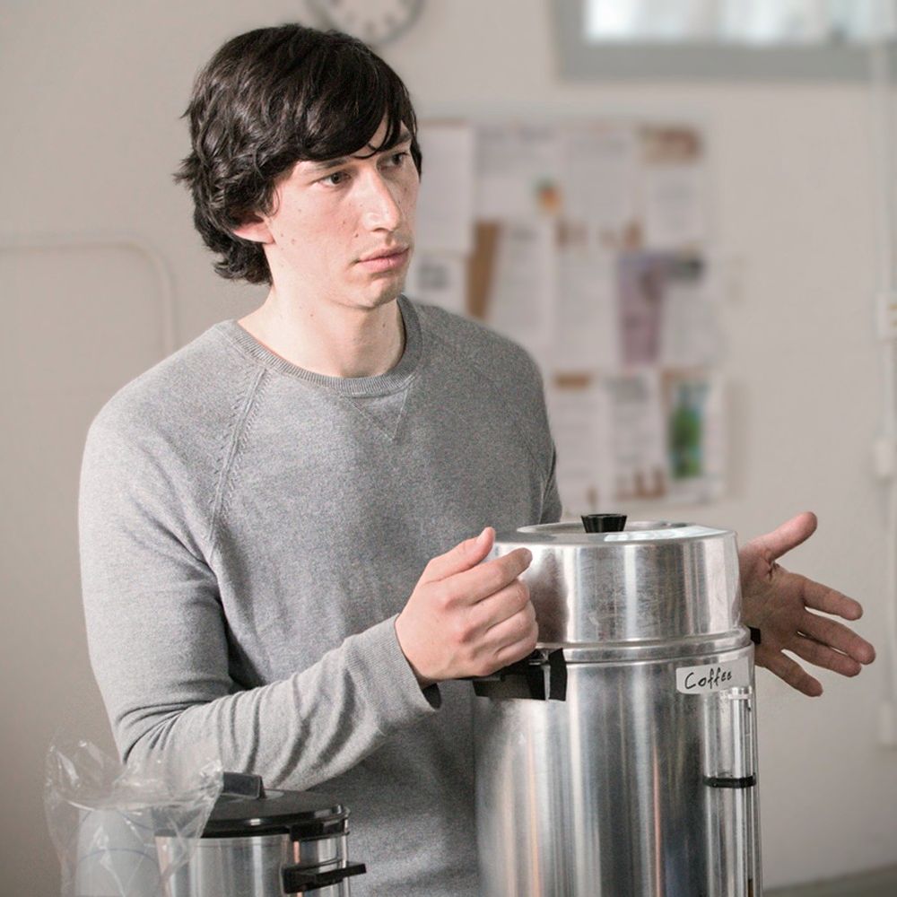 Adam Driver as Adam Sackler at an AA meeting with his hands on a coffee dispenser