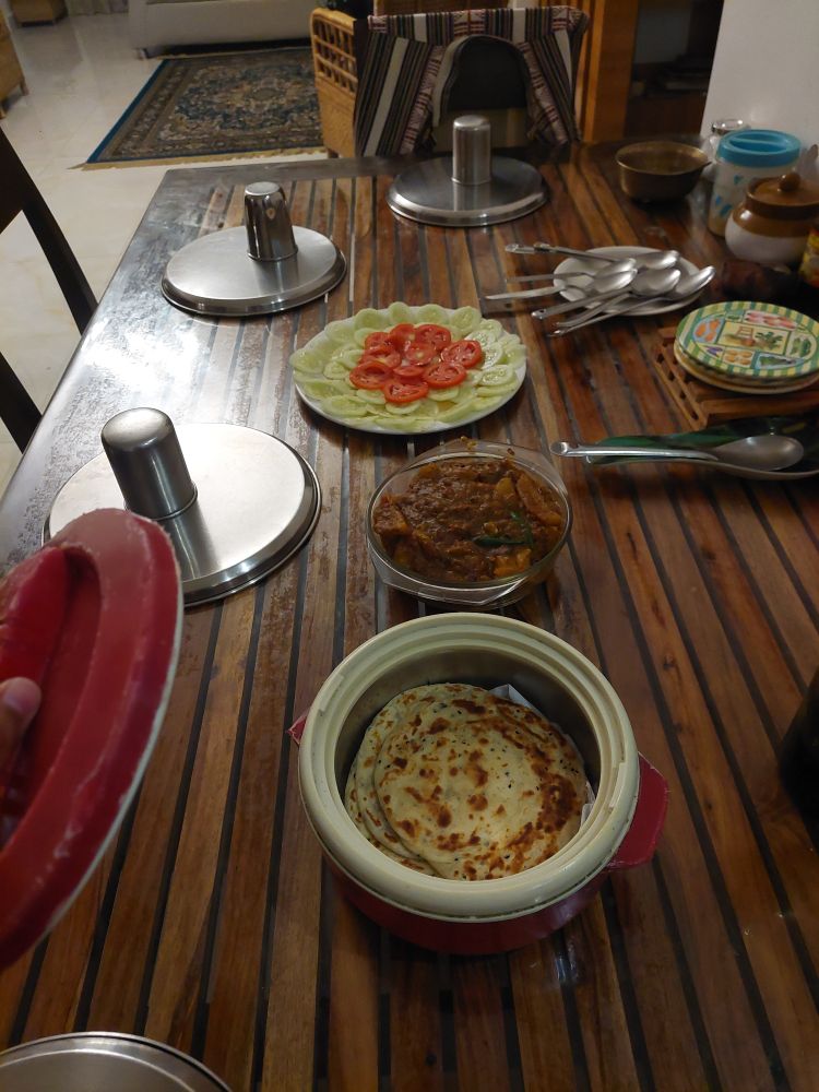 Ajwain Parathas, egg curry, and salad
