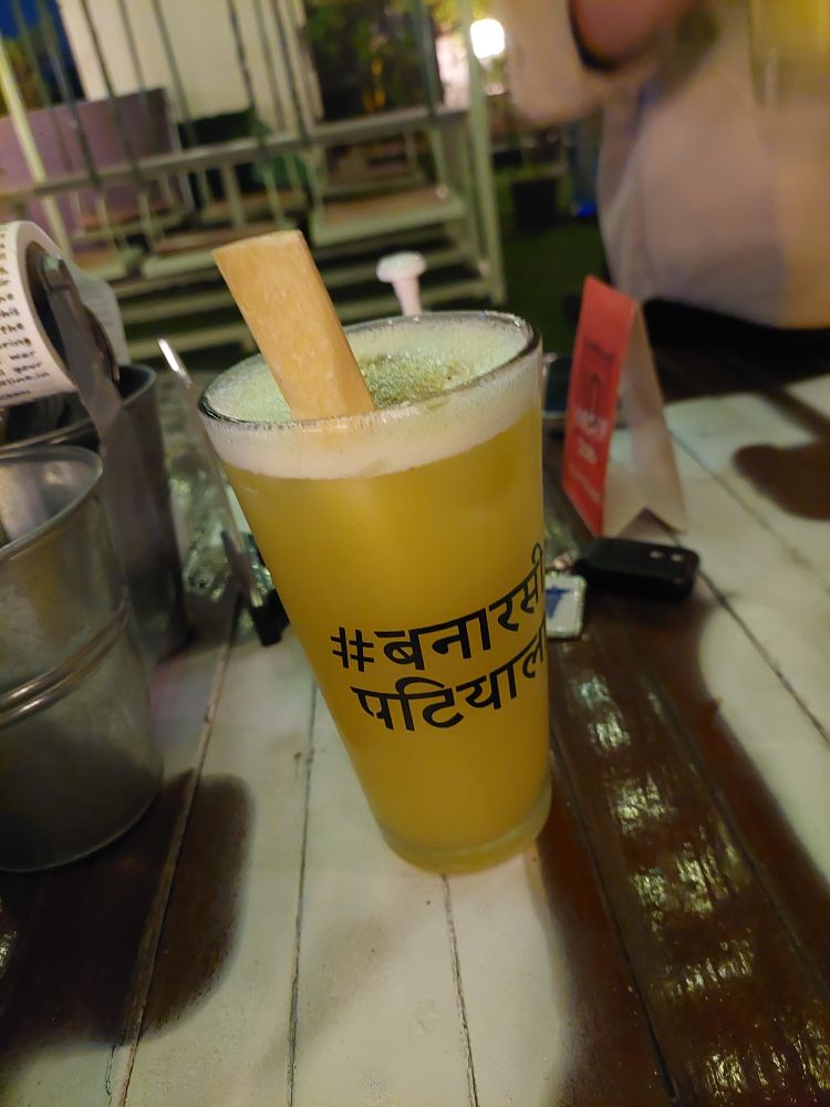 Sugarcane cocktail with a a sugarcane stick stirrer that was tasty too - some of the writing is obscured but I think it said banarasi patiala 