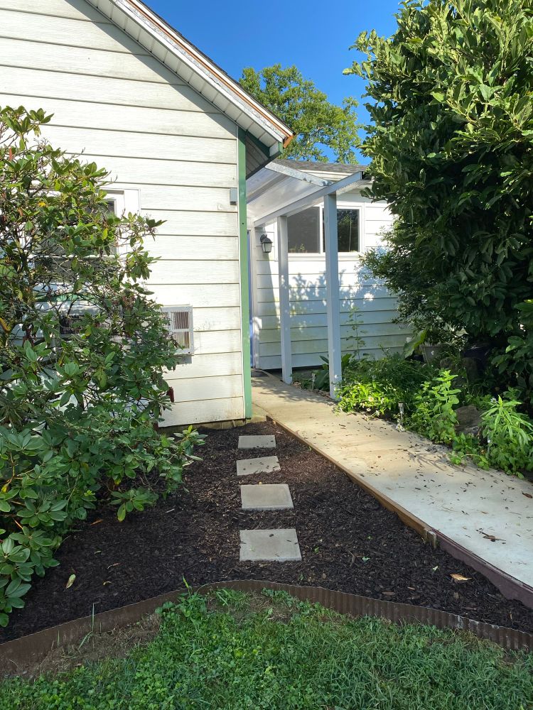 The trickiest area of the flower bed next to the sidewalk in my front door, but I fixed the trench and laid the edging down and put all the cardboard and mulch down as well, and there’s four pavers that kind of cut across because I know people will do that (including myself!) towards the sidewalk