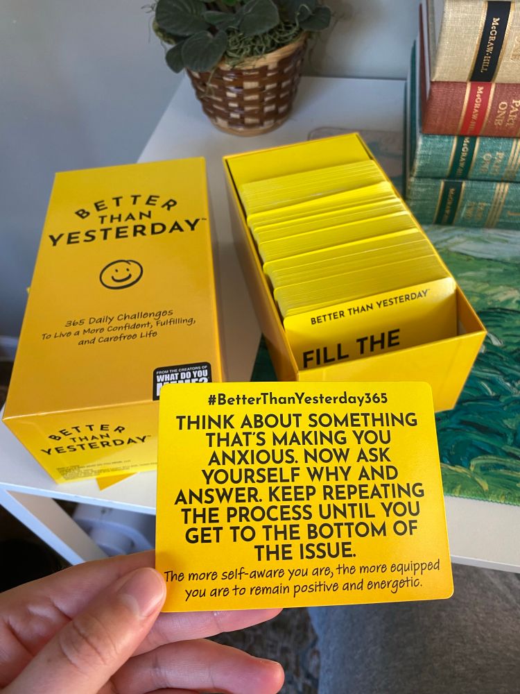 Here’s me showing the back of the card that says: 

#BetterThanYesterday365
THINK ABOUT SOMETHING
THAT'S MAKING YOU ANXIOUS. NOW ASK YOURSELF WHY AND ANSWER. KEEP REPEATING THE PROCESS UNTIL YOU GET TO THE BOTTOM OF THE ISSUE.
The more self-aware you are, the more equipped you are to remain positive and energetic.