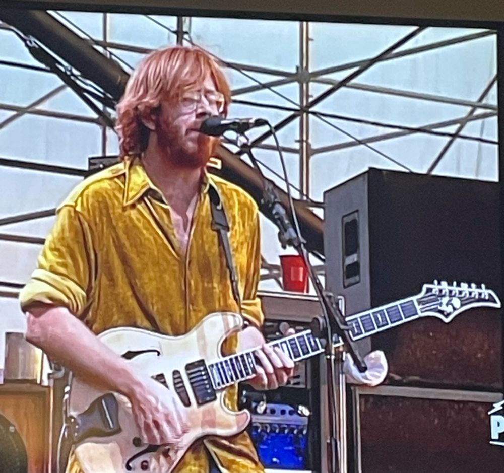 Trey Anastasio from Phish playing guitar in a velour gold shirt at Clifford Ball 1996