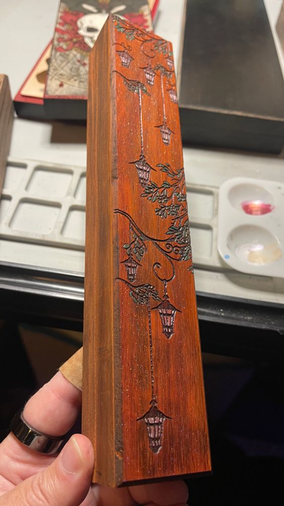 Wood dice vault with hanging lanterns etched and painted with a shimmering finish