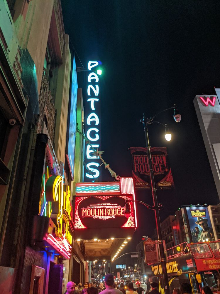 Pantages sign with Moulin Rouge in lights beneath it on Hollywood Blvd
