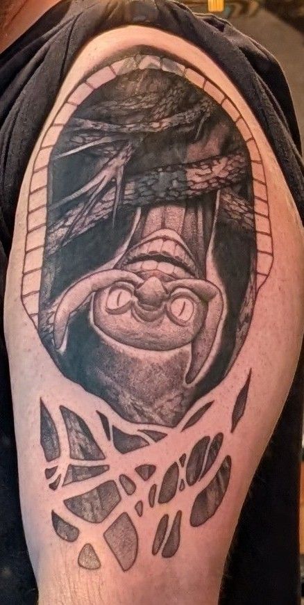 A black and grey tattoo of Frampt from Dark Souls 1 on someone's upper right arm. 