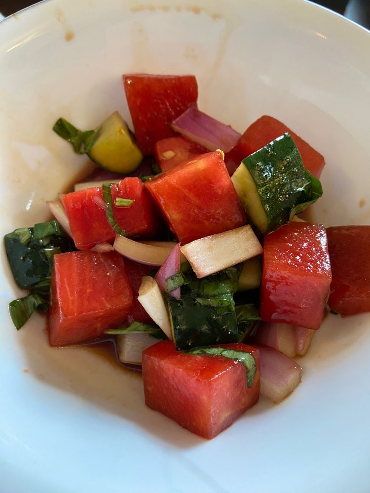 Watermelon, cucumbers, red onion, fresh basil in a balsamic vinegar sauce 